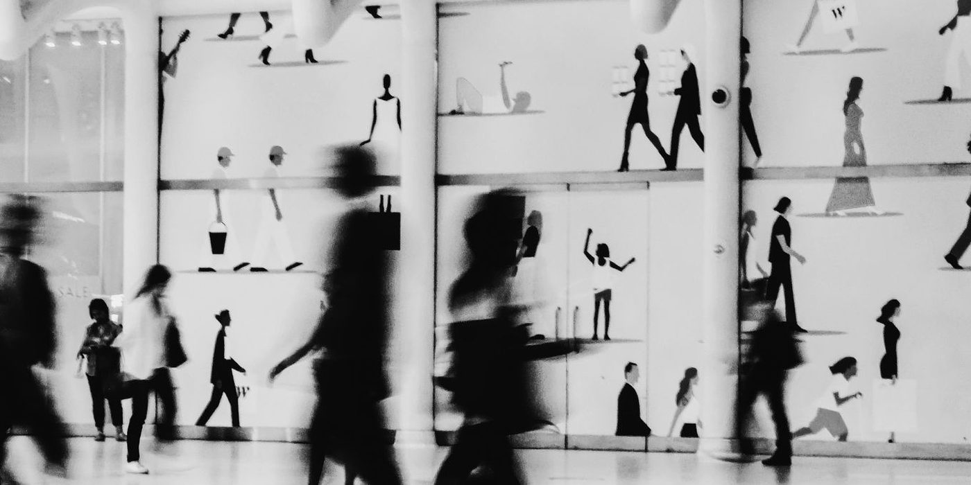 Shoppers blurred by motion as they walk through a shopping centre
